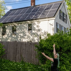 Excited woman showing off her new solar panels